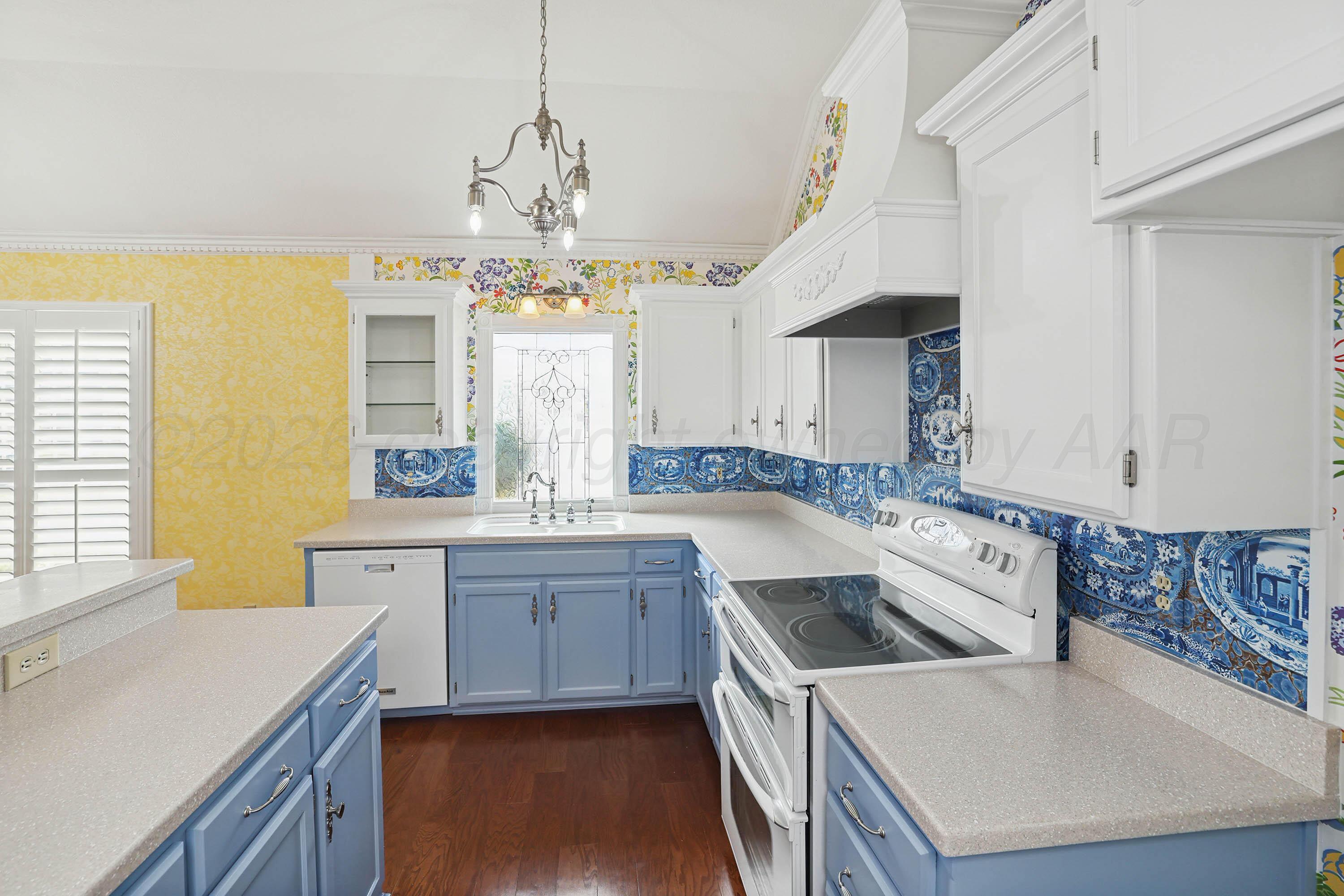 6904 Alpine Lane Amarillo, TX 79109 - Photo 9 of 45 a kitchen with stainless steel appliances granite countertop a sink a stove and a refrigerator