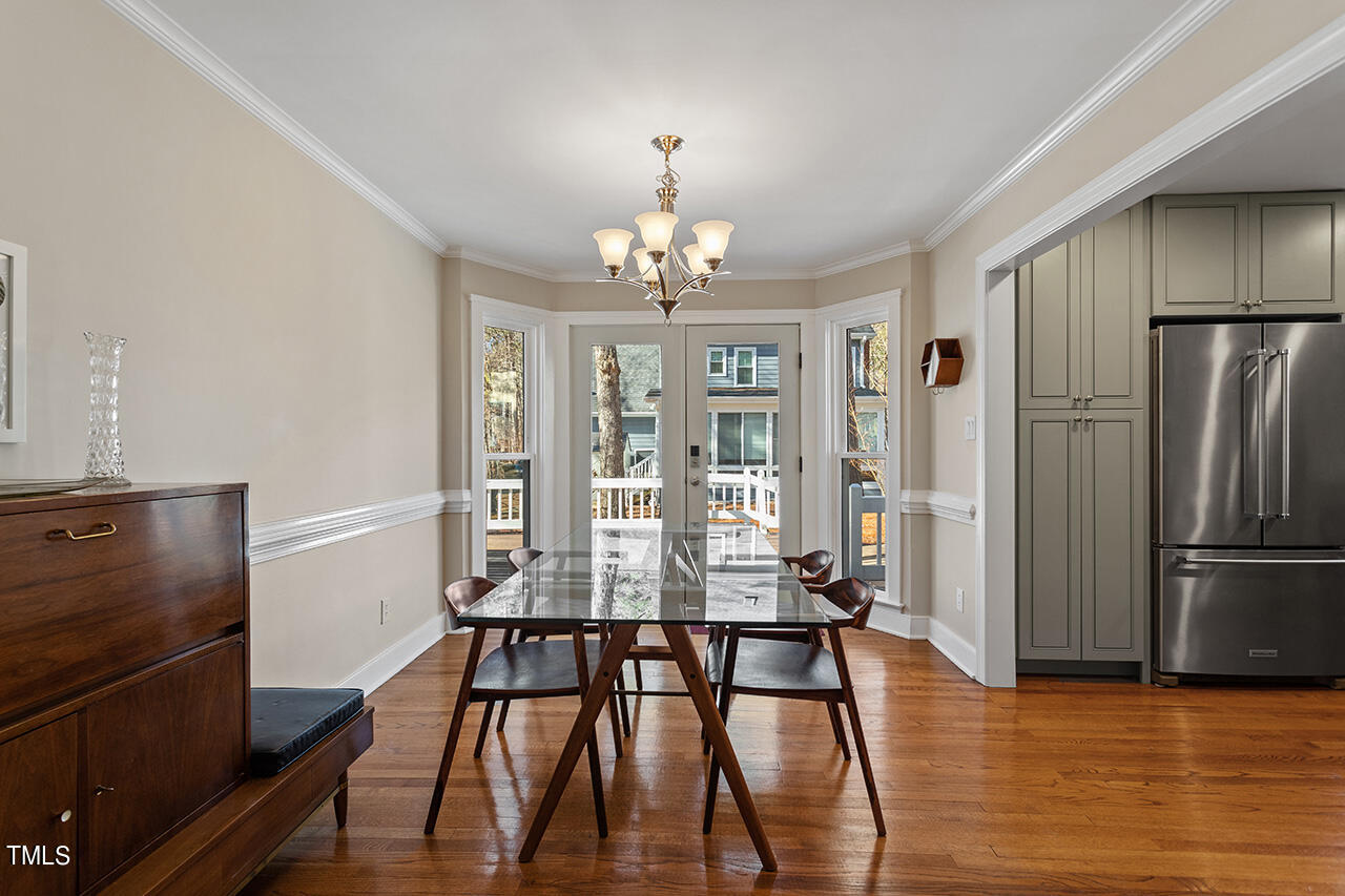 6933 Sandringham Drive Raleigh, NC 27613 - Photo 14 of 30 a view of a dining room with furniture window and wooden floor