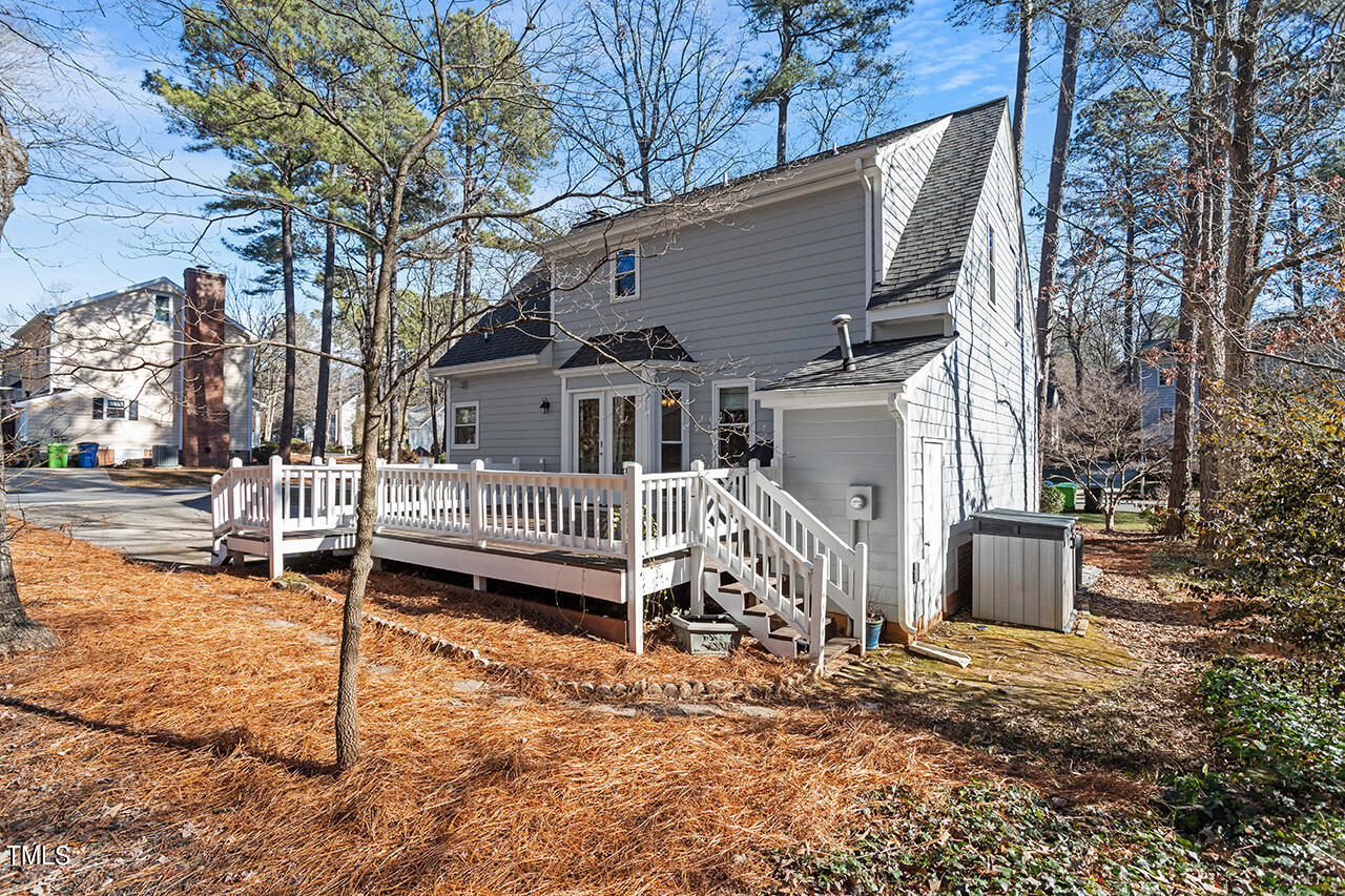 6933 Sandringham Drive Raleigh, NC 27613 - Photo 27 of 30 a white house that has a small yard and a large tree