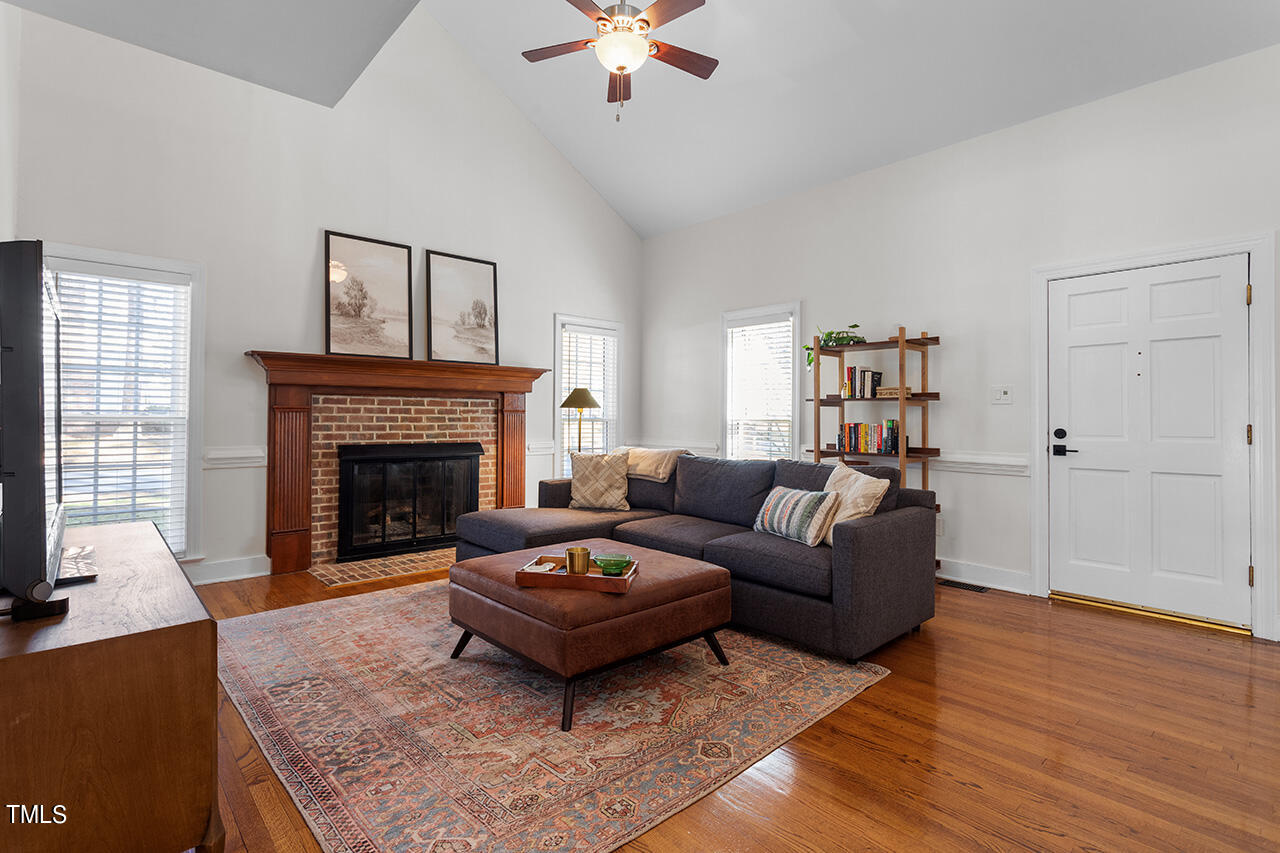 6933 Sandringham Drive Raleigh, NC 27613 - Photo 5 of 30 a living room with furniture and a fireplace
