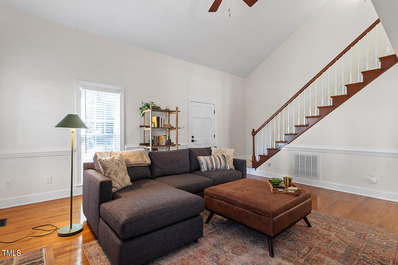 6933 Sandringham Drive Raleigh, NC 27613 - Photo 6 of 30 a living room with furniture and a dining table