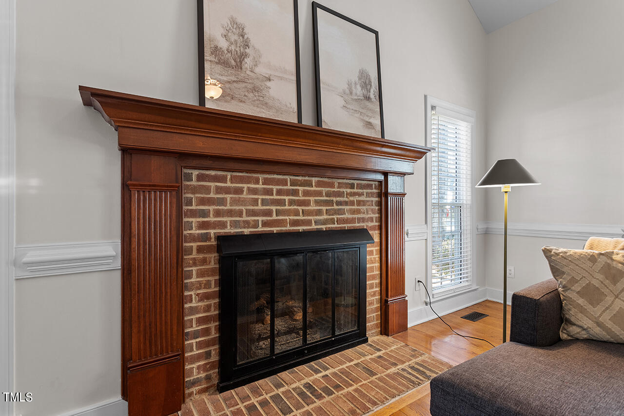 6933 Sandringham Drive Raleigh, NC 27613 - Photo 8 of 30 a living room with furniture and a fireplace