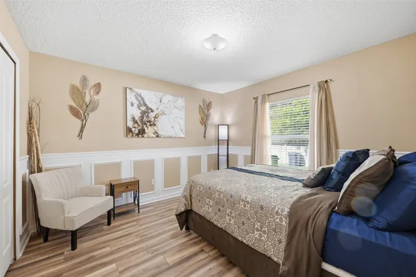 a bedroom with a bed and a chair