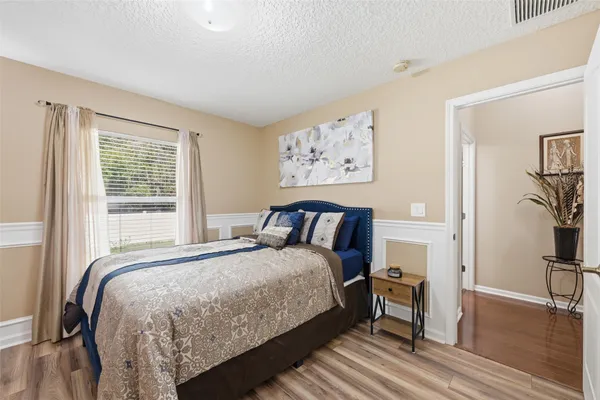 a bedroom with a bed and a large window