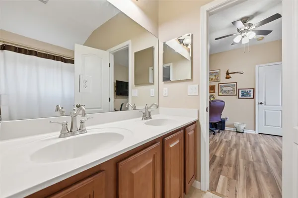 a en suite bathroom with a sink double vanity and a mirror