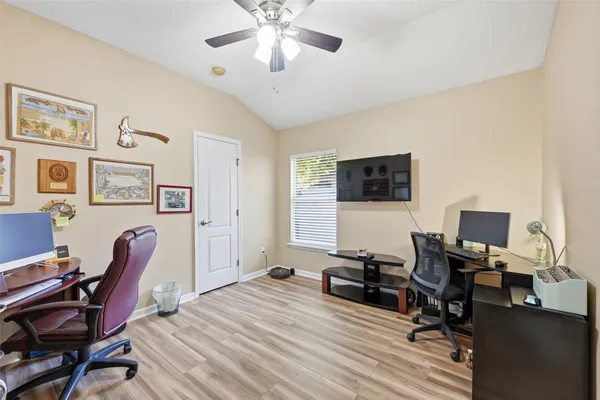 a view of a livingroom with workspace and a window