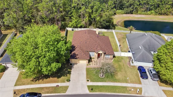 an aerial view of a house with yard swimming pool and outdoor seating