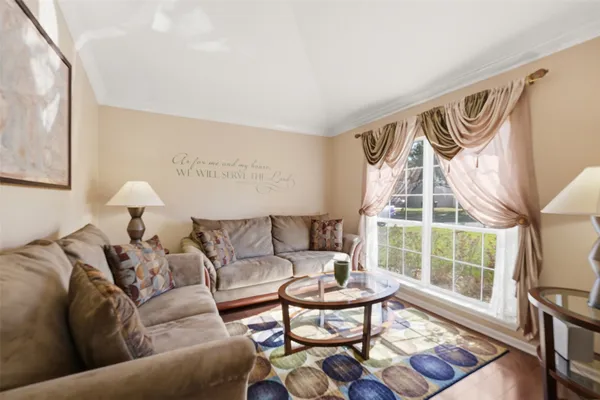 a living room with furniture and a floor to ceiling window