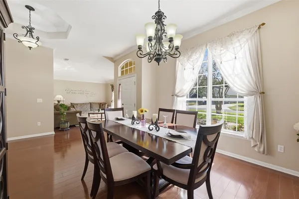 a view of a dining room with furniture window and wooden floor