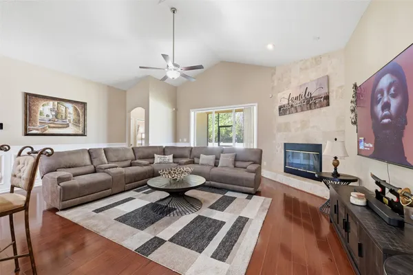 a living room with furniture a fireplace and a chandelier