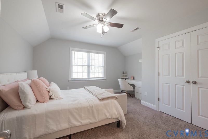 9425 Marie Road New Kent, VA 23124 - Photo 43 of 55 a bedroom with a large bed and a chandelier