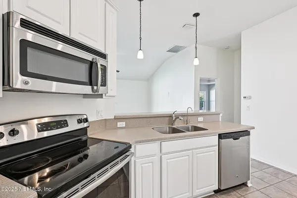 a kitchen with a stove and a microwave