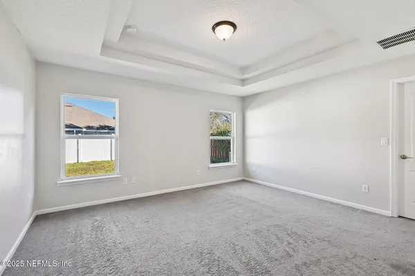 an empty room with windows and closet