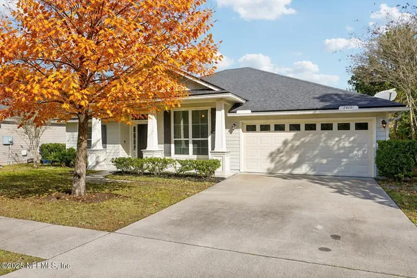 a front view of house with yard and trees around