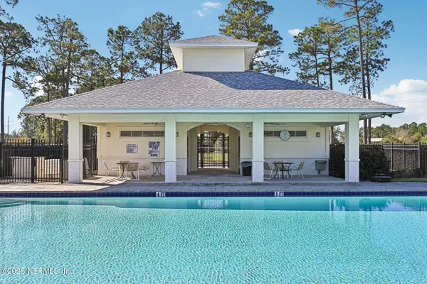 a view of a swimming pool and trees in the patio