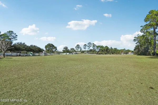 front view of a house with a large window and potted plants
