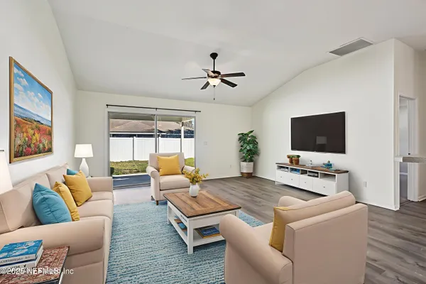 a living room with furniture and a flat screen tv