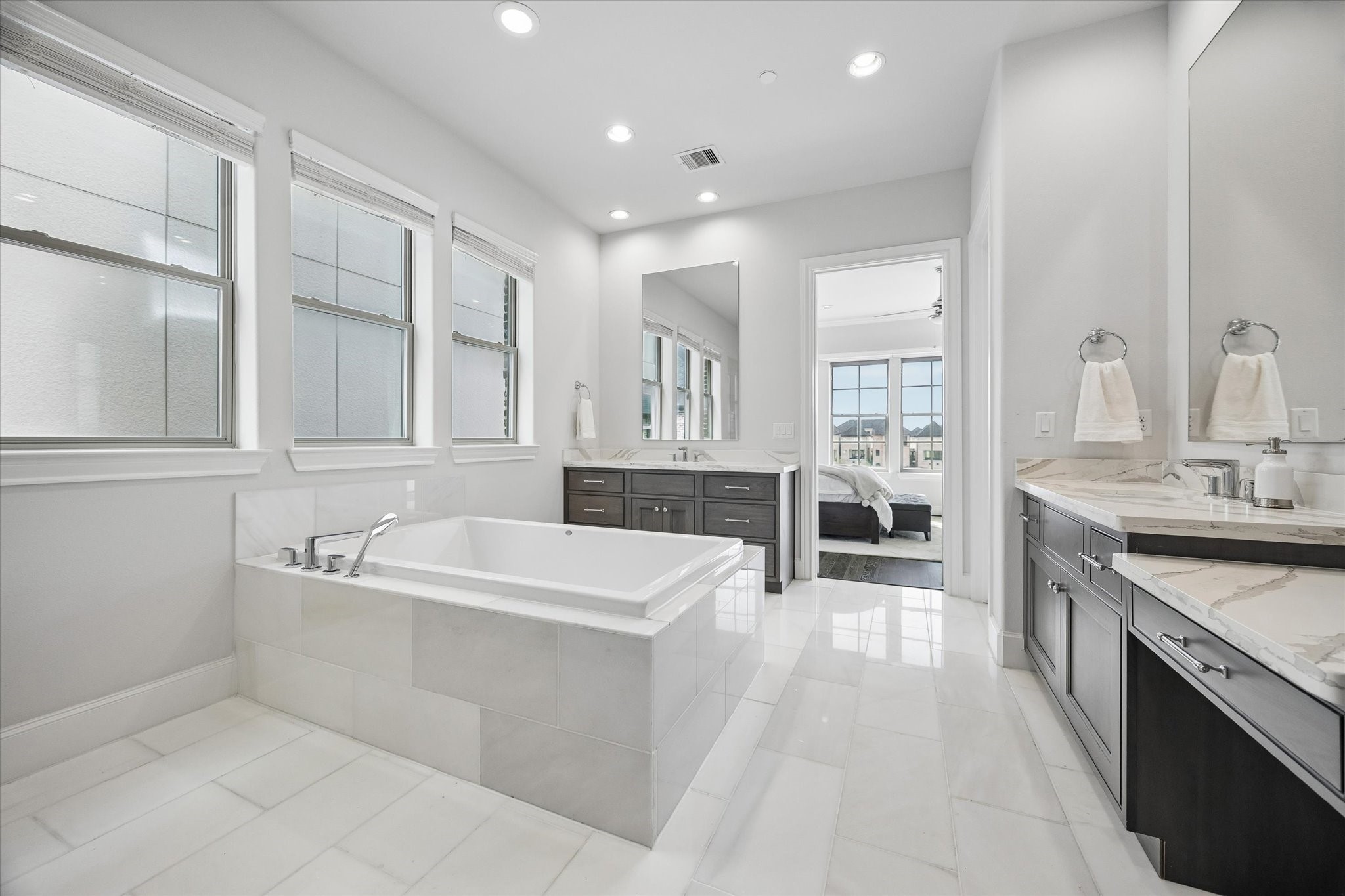2727 Maxroy Street Houston, TX 77007 - Photo 23 of 46 a large bathroom with a double vanity sink a mirror and a bathtub