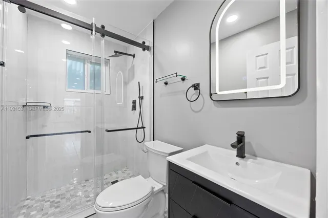 a bathroom with a sink toilet and shower