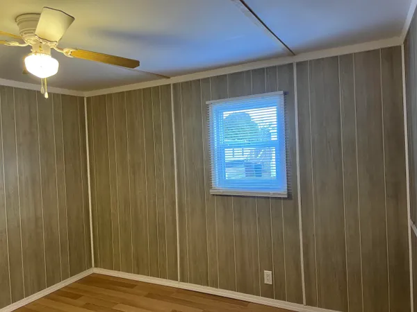 a view of a livingroom with a chandelier fan