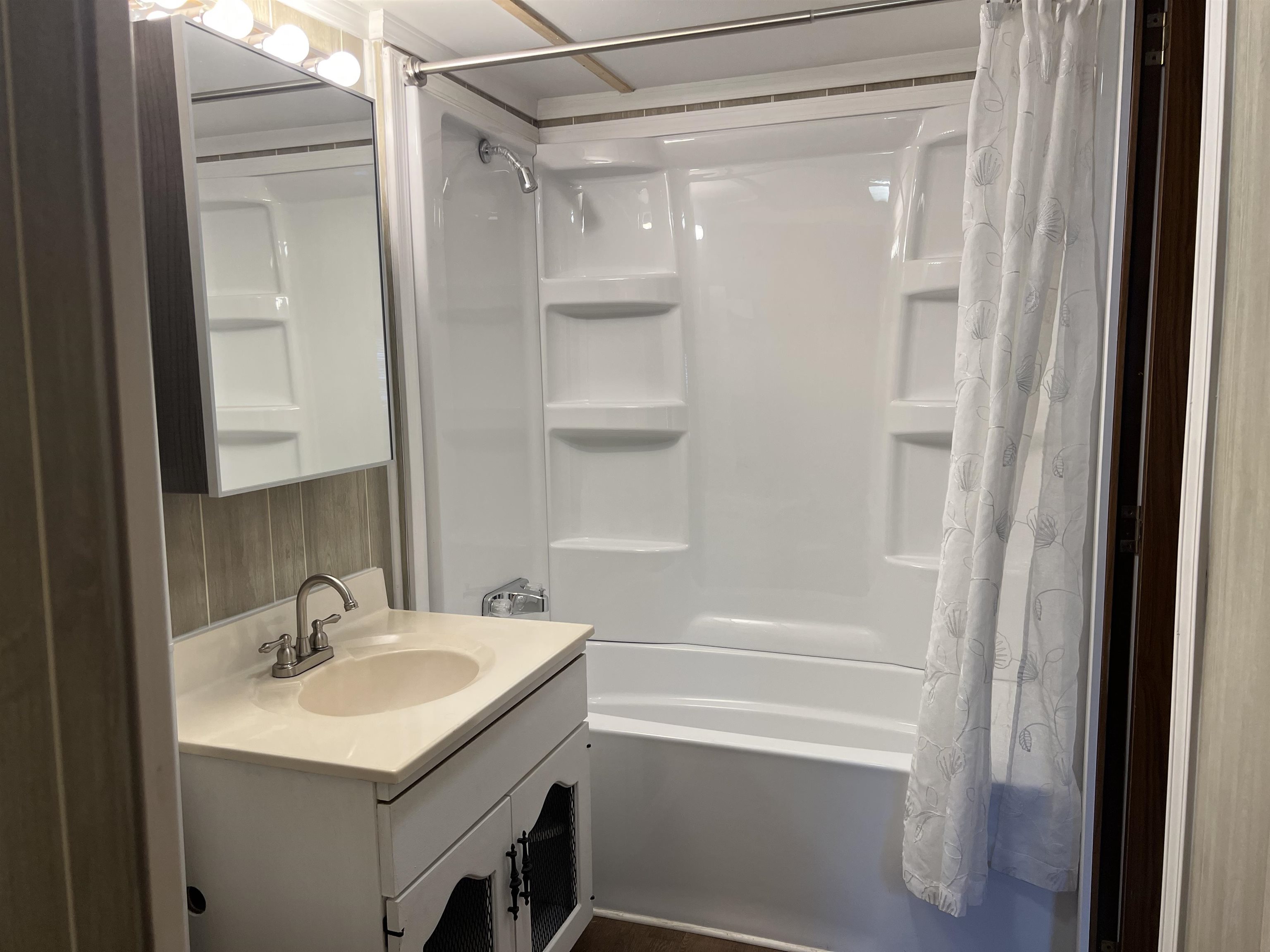 2107 Rivington Road Loves Park, IL 61111 - Photo 16 of 18 a bathroom with a sink a mirror and a shower