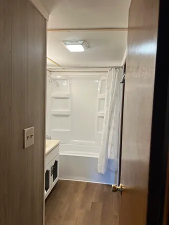 a bathroom with a glass shower door