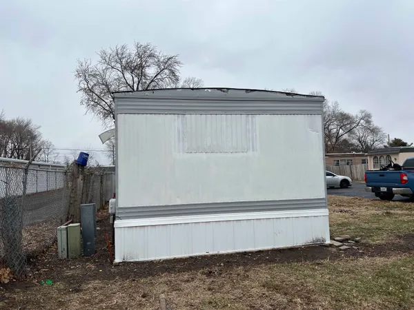 a view of backyard with parked car