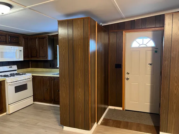 a kitchen with a refrigerator and a stove top oven
