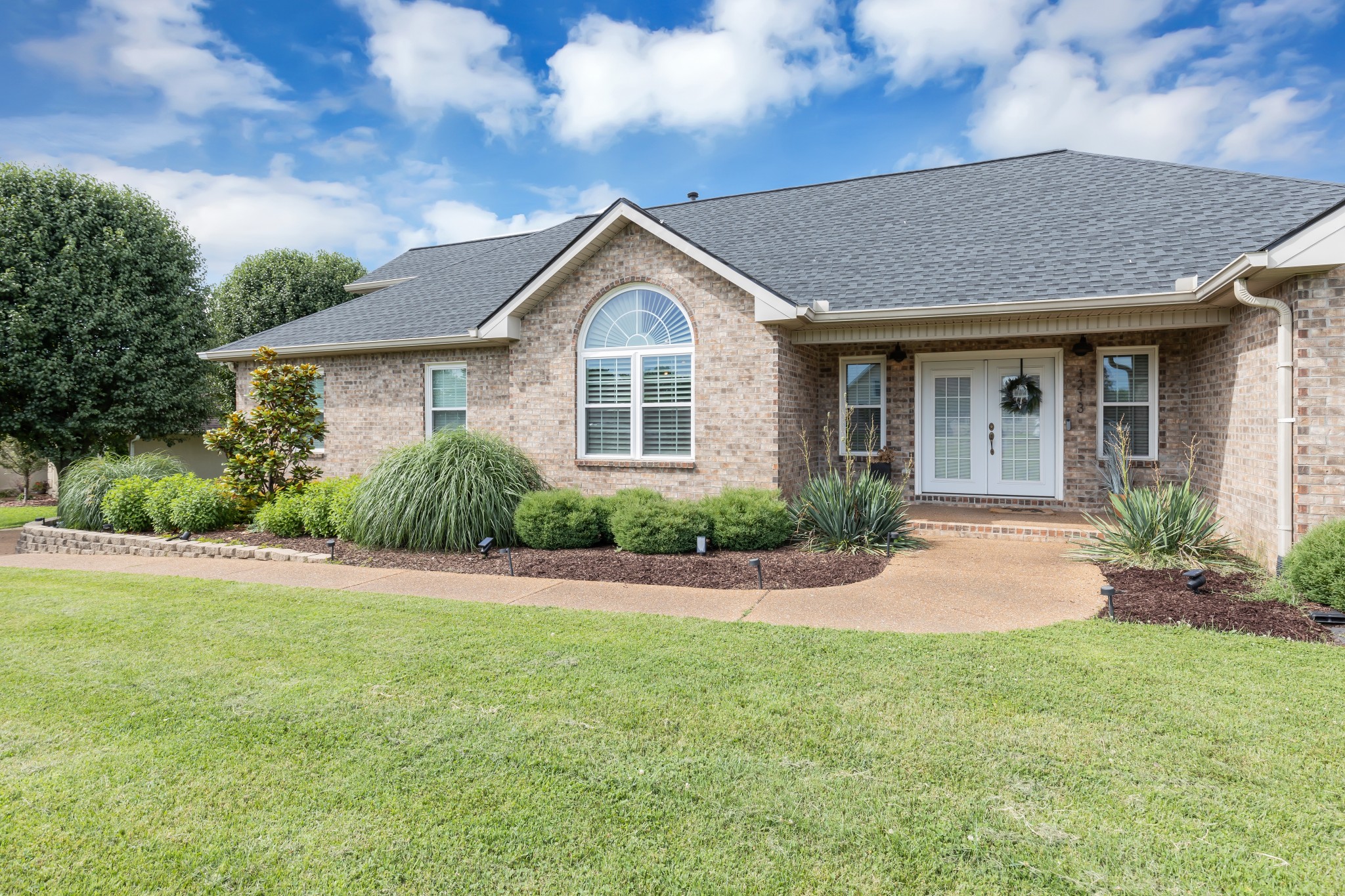 1213 Hunters Point Lane Spring Hill, TN 37174 - Photo 4 of 30 a front view of a house with a garden