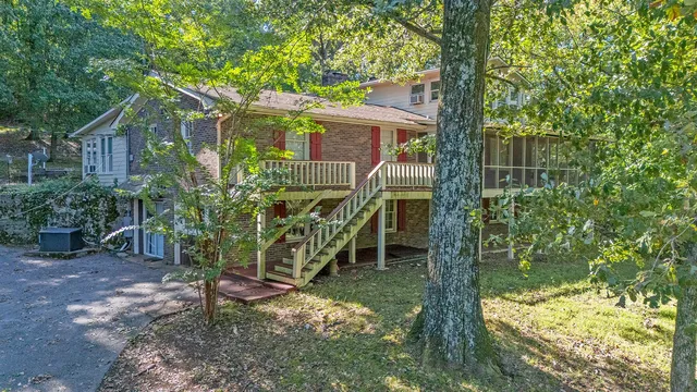 a view of a house with backyard and sitting area