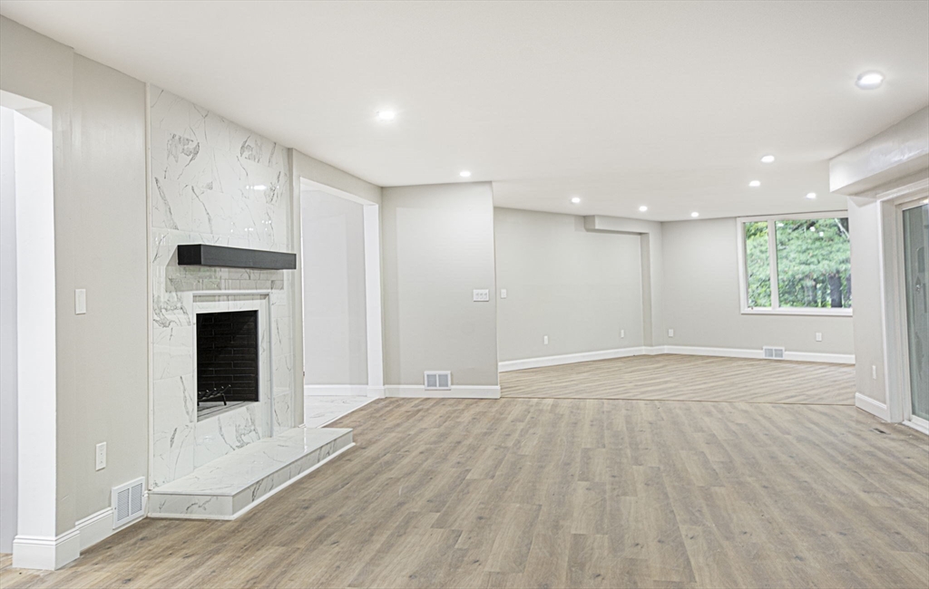 32 Aylesbury Road Worcester, MA 01609 - Photo 12 of 42 a view of an empty room with wooden floor and a window
