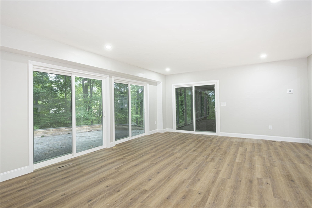 32 Aylesbury Road Worcester, MA 01609 - Photo 15 of 42 a view of an empty room with wooden floor and a window