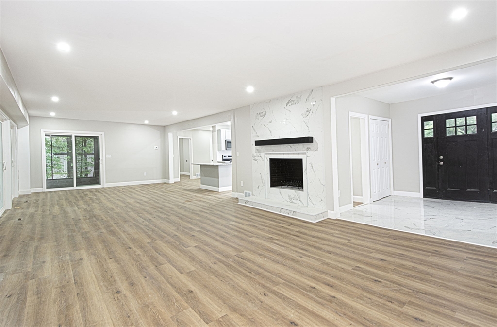 32 Aylesbury Road Worcester, MA 01609 - Photo 19 of 42 a view of empty room with wooden floor and fireplace