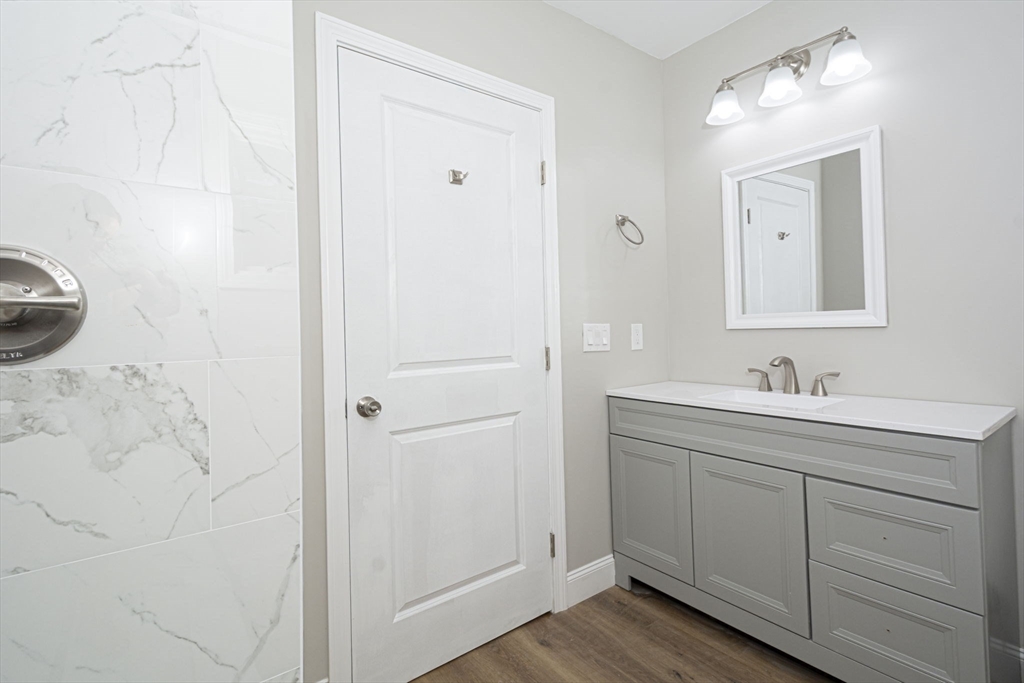 32 Aylesbury Road Worcester, MA 01609 - Photo 26 of 42 a bathroom with a granite countertop sink and a mirror