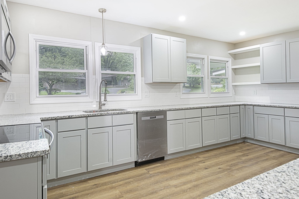 32 Aylesbury Road Worcester, MA 01609 - Photo 8 of 42 a kitchen with a sink window and cabinets