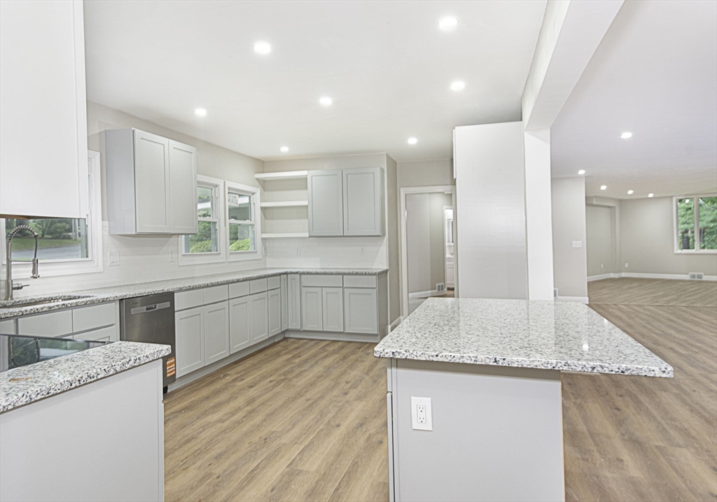 32 Aylesbury Road Worcester, MA 01609 - Photo 9 of 42 a kitchen with granite countertop kitchen island a sink appliances and cabinets
