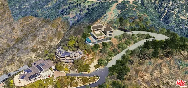an aerial view of a house with a yard and large trees