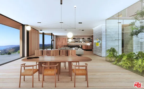 a kitchen with stainless steel appliances kitchen island granite countertop a table chairs and a refrigerator