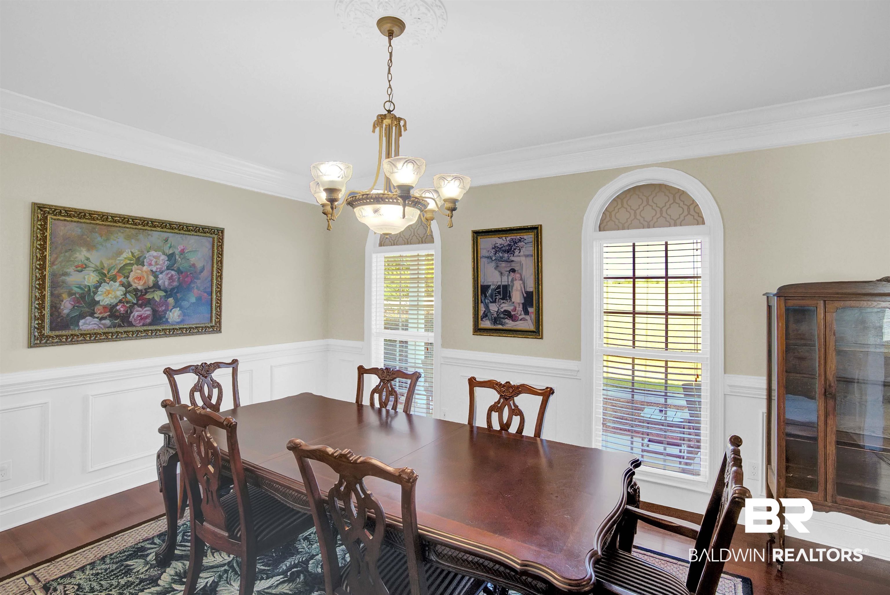 27688 Rigsby Road Daphne, AL 36526 - Photo 12 of 56 Dining area with crown molding, wood-type flooring, and a chandelier