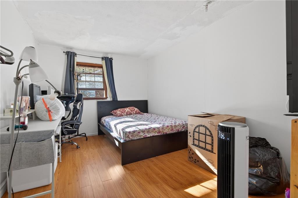 6728 Angels Lane Tucker, GA 30084 - Photo 12 of 54 a bedroom with a bed and wooden floor