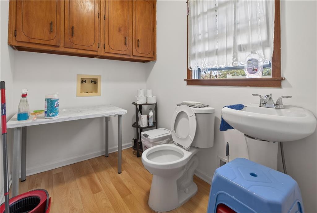 6728 Angels Lane Tucker, GA 30084 - Photo 16 of 54 a bathroom with a sink a toilet and a window