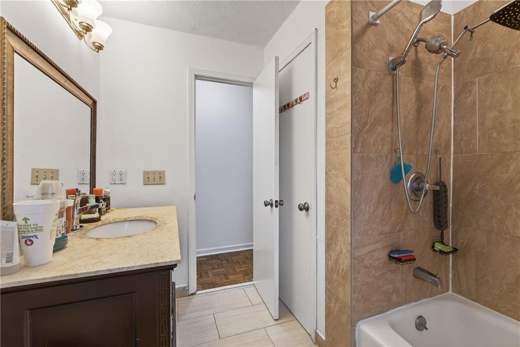 6728 Angels Lane Tucker, GA 30084 - Photo 18 of 54 a bathroom with a tub sink shower and mirror