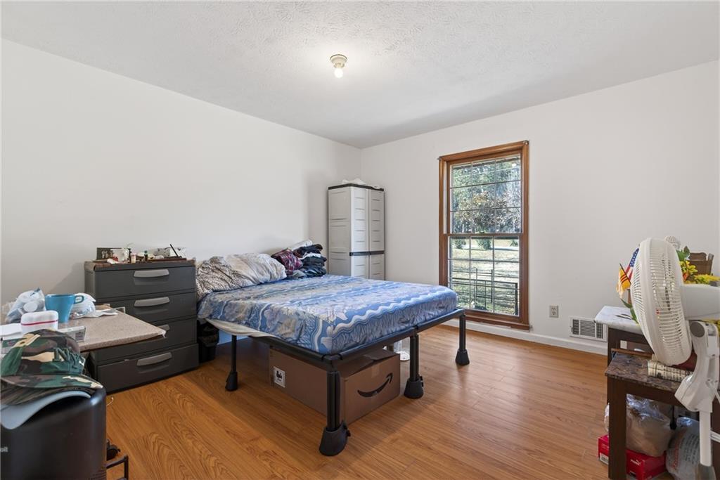 6728 Angels Lane Tucker, GA 30084 - Photo 19 of 54 a room with a bed and wooden floor