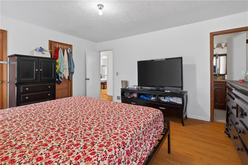 6728 Angels Lane Tucker, GA 30084 - Photo 25 of 54 a bedroom with a bed and a flat screen tv