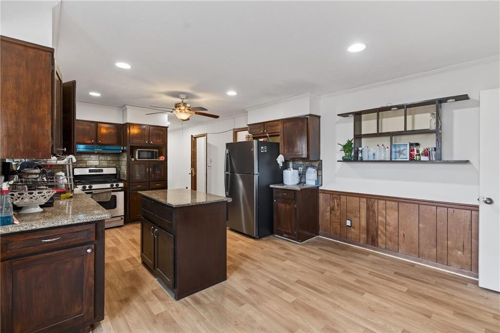 6728 Angels Lane Tucker, GA 30084 - Photo 5 of 54 a kitchen with stainless steel appliances kitchen island granite countertop a refrigerator and a stove top oven