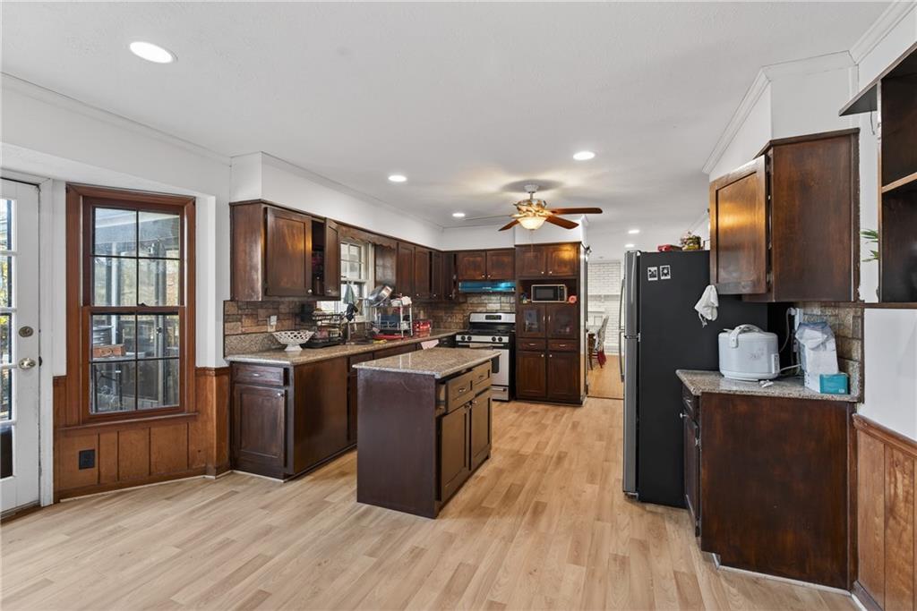 6728 Angels Lane Tucker, GA 30084 - Photo 6 of 54 a kitchen with stainless steel appliances granite countertop a refrigerator stove and oven