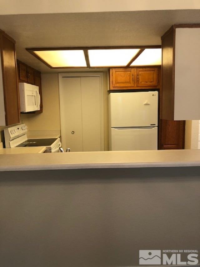 4227 Baker Lane Reno, NV 89509 - Photo 8 of 27 a bathroom with a sink and a refrigerator