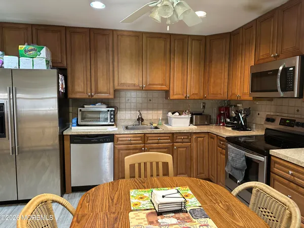 a kitchen with a refrigerator stove and sink