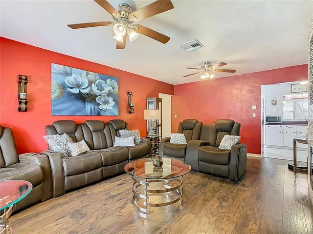 a living room with furniture a rug and a large window