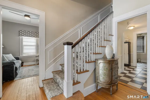 a view of entryway and hall with wooden floor